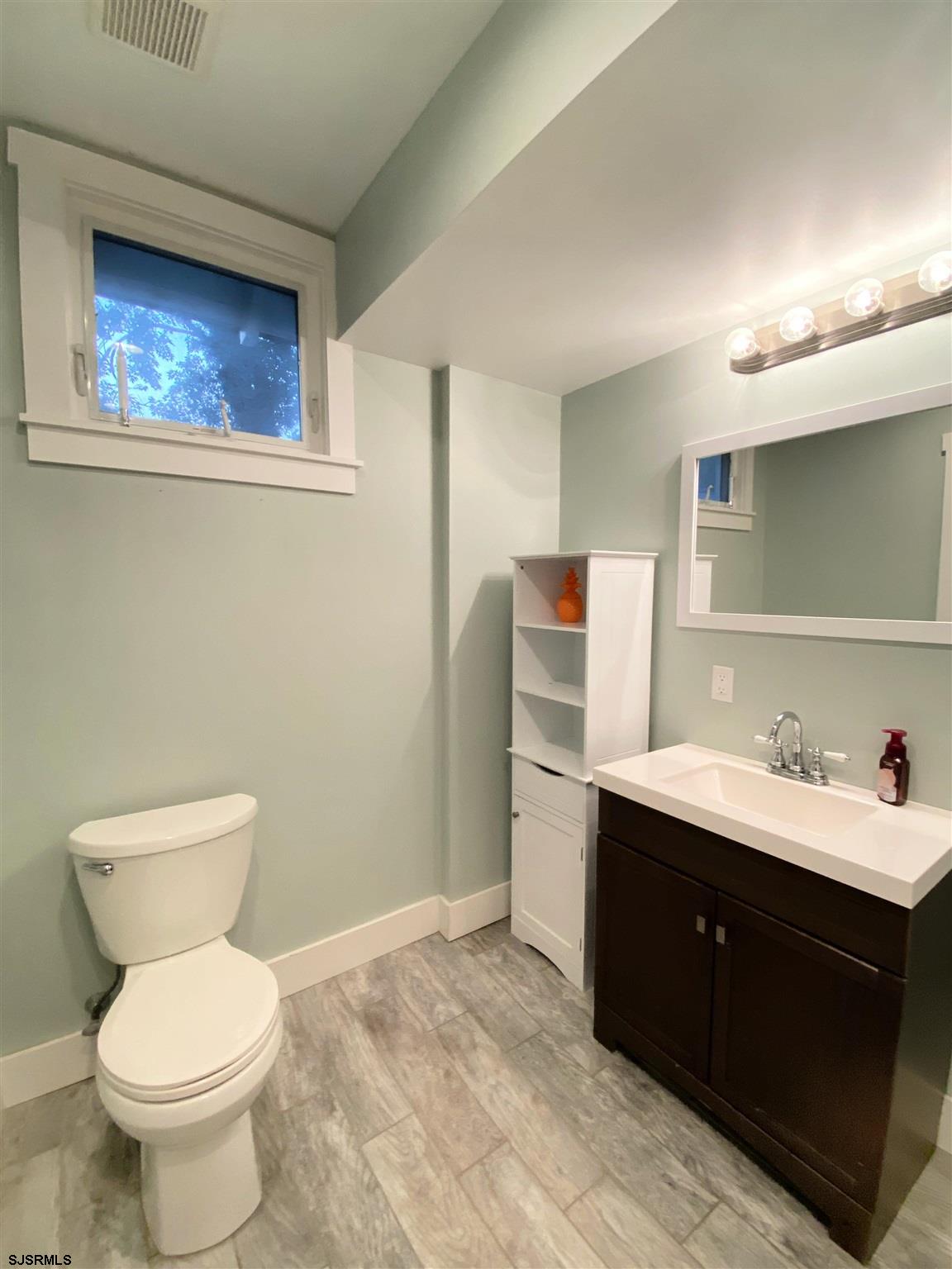220 West Mill Road Northfield, NJ 08225 - Photo 9 of 22 a bathroom with a toilet sink and mirror