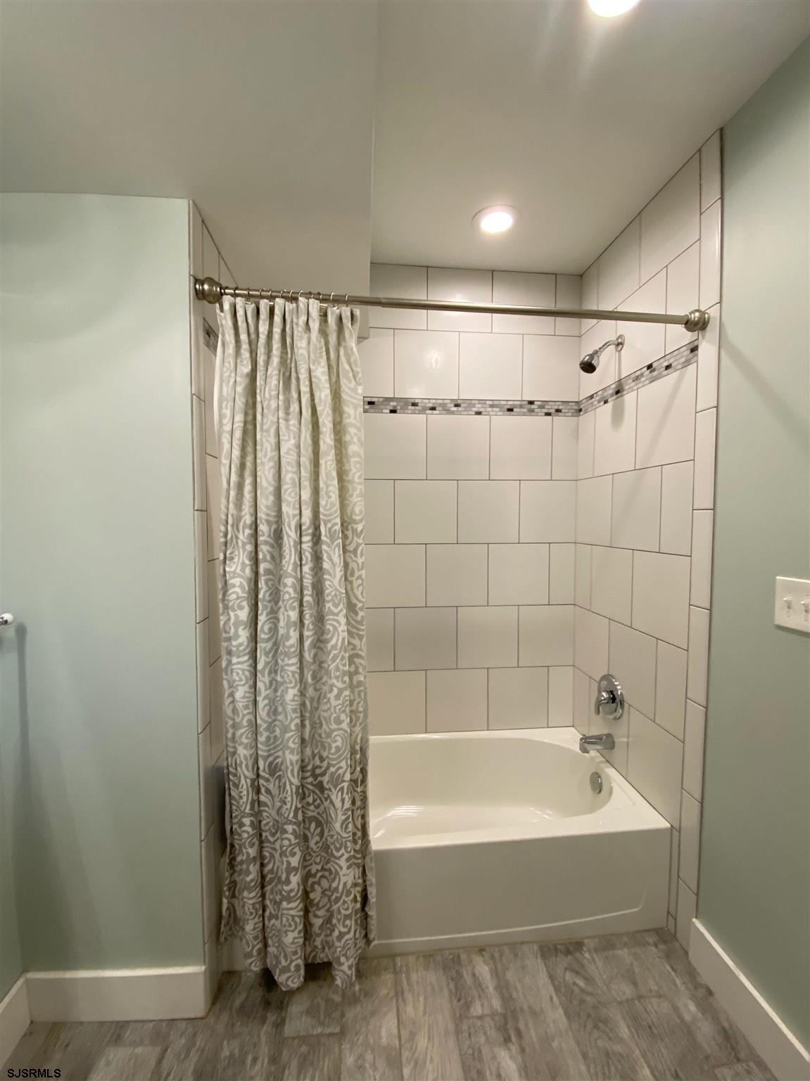 220 West Mill Road Northfield, NJ 08225 - Photo 10 of 22 a bathroom with a bathtub and shower