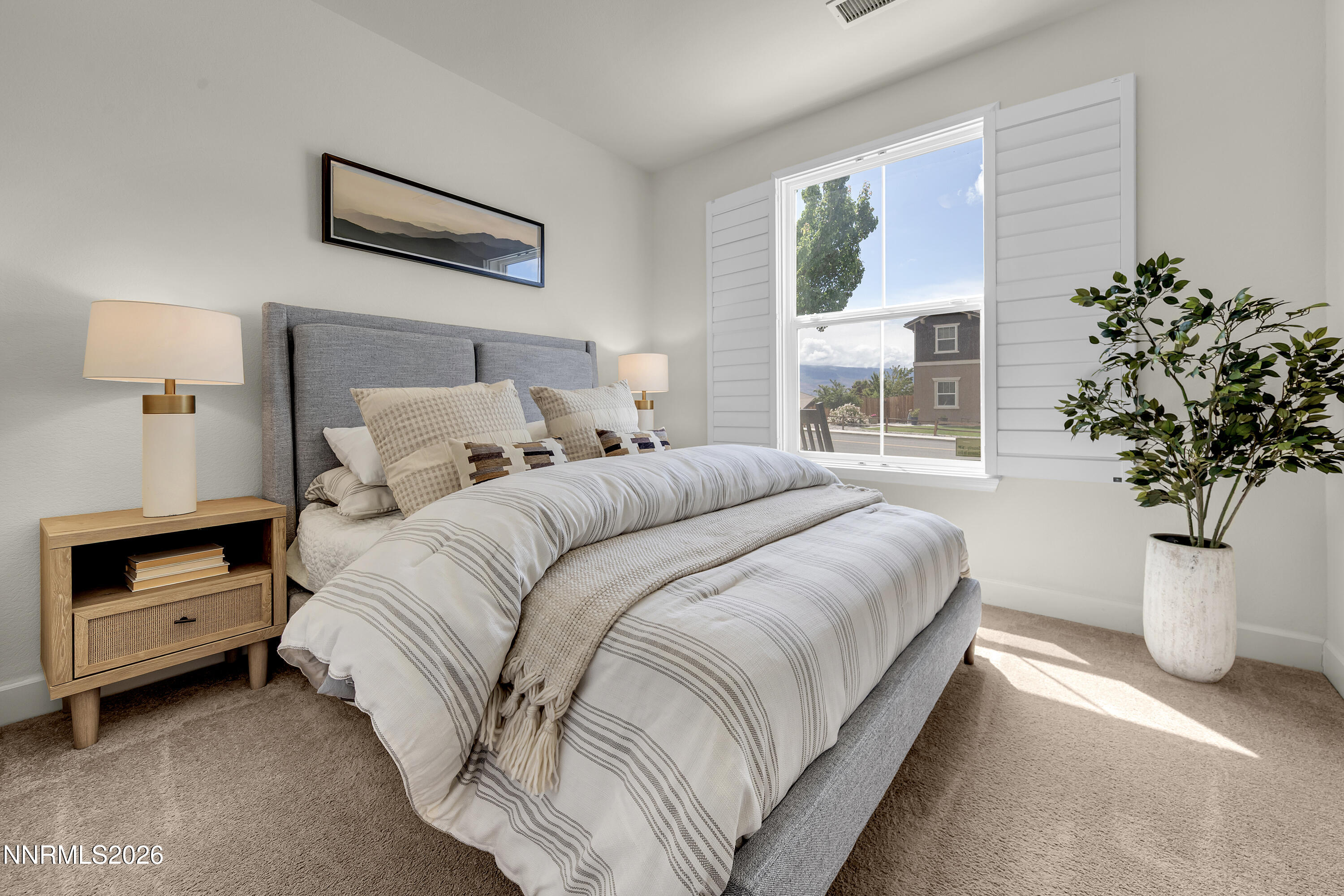 10150 Barrel Racer Drive Reno, NV 89521 - Photo 22 of 64 a bedroom with a bed and a potted plant