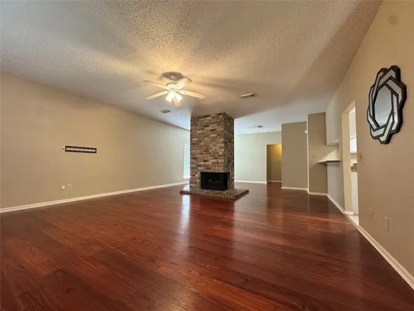 a kitchen with granite countertop a refrigerator and a stove top oven