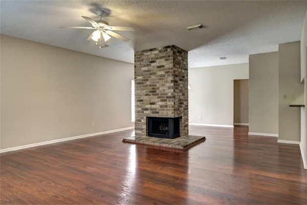 a kitchen with granite countertop a stove a sink and a microwave