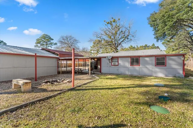 a view of a house with backyard porch and sitting area