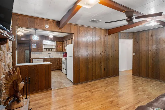 a view of a kitchen with wooden floor and a window