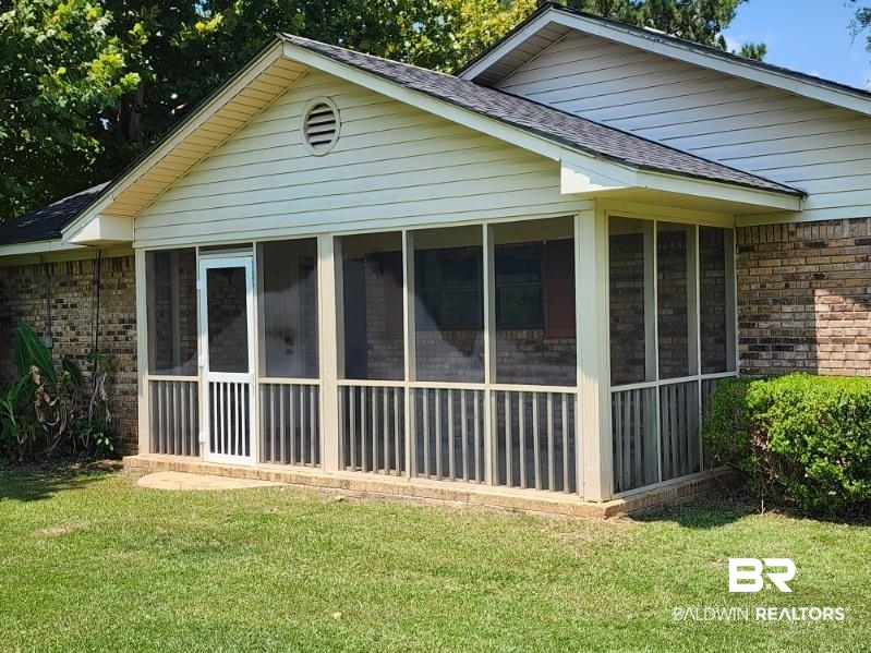 640 Horseshoe Road Brewton, AL 36426 - Photo 2 of 22 View of property exterior with a sunroom and a yard