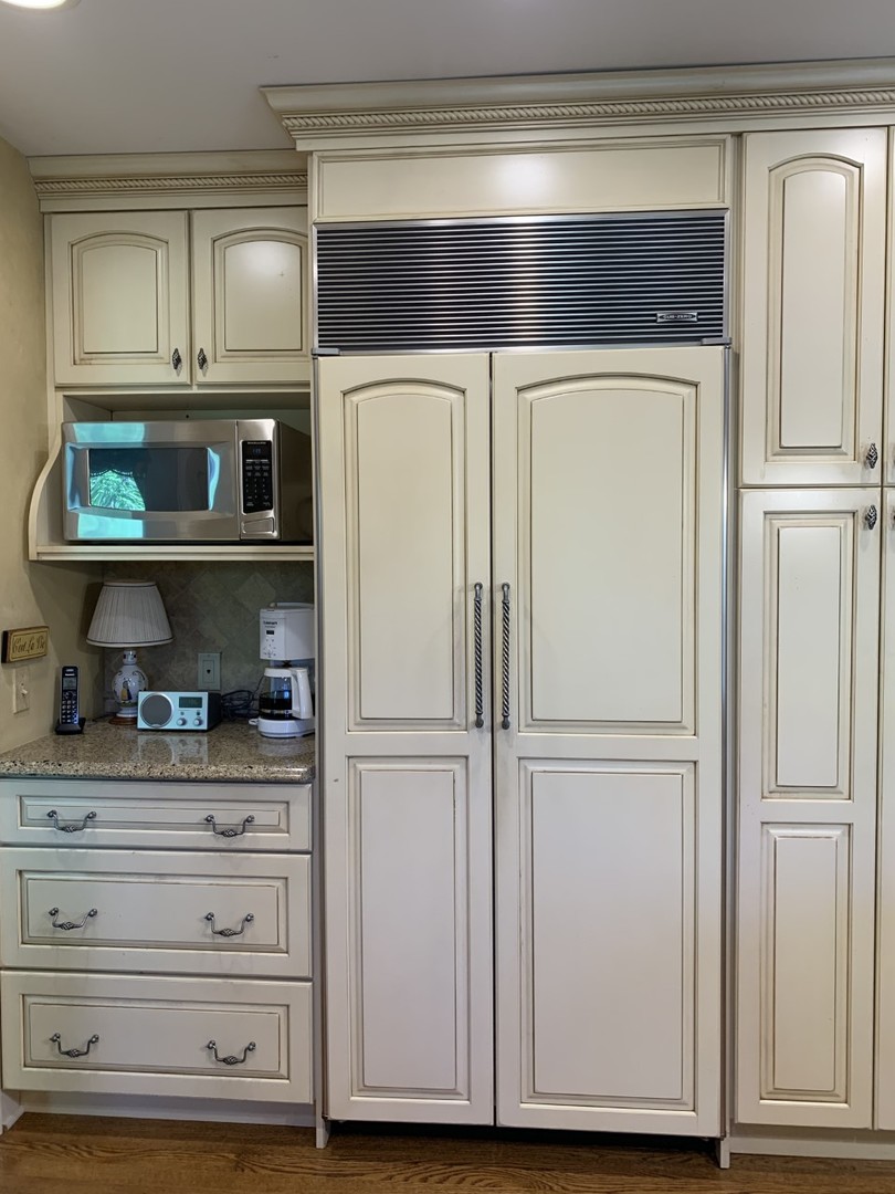 1219 Howard Circle Wheaton, IL 60187 - Photo 11 of 26 a kitchen with white cabinets and a refrigerator