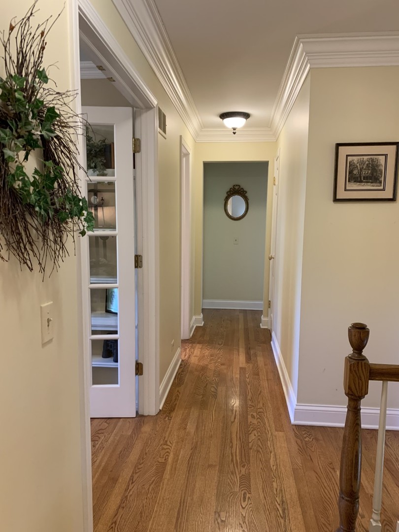 1219 Howard Circle Wheaton, IL 60187 - Photo 15 of 26 a view of a hallway view with wooden floor and staircase