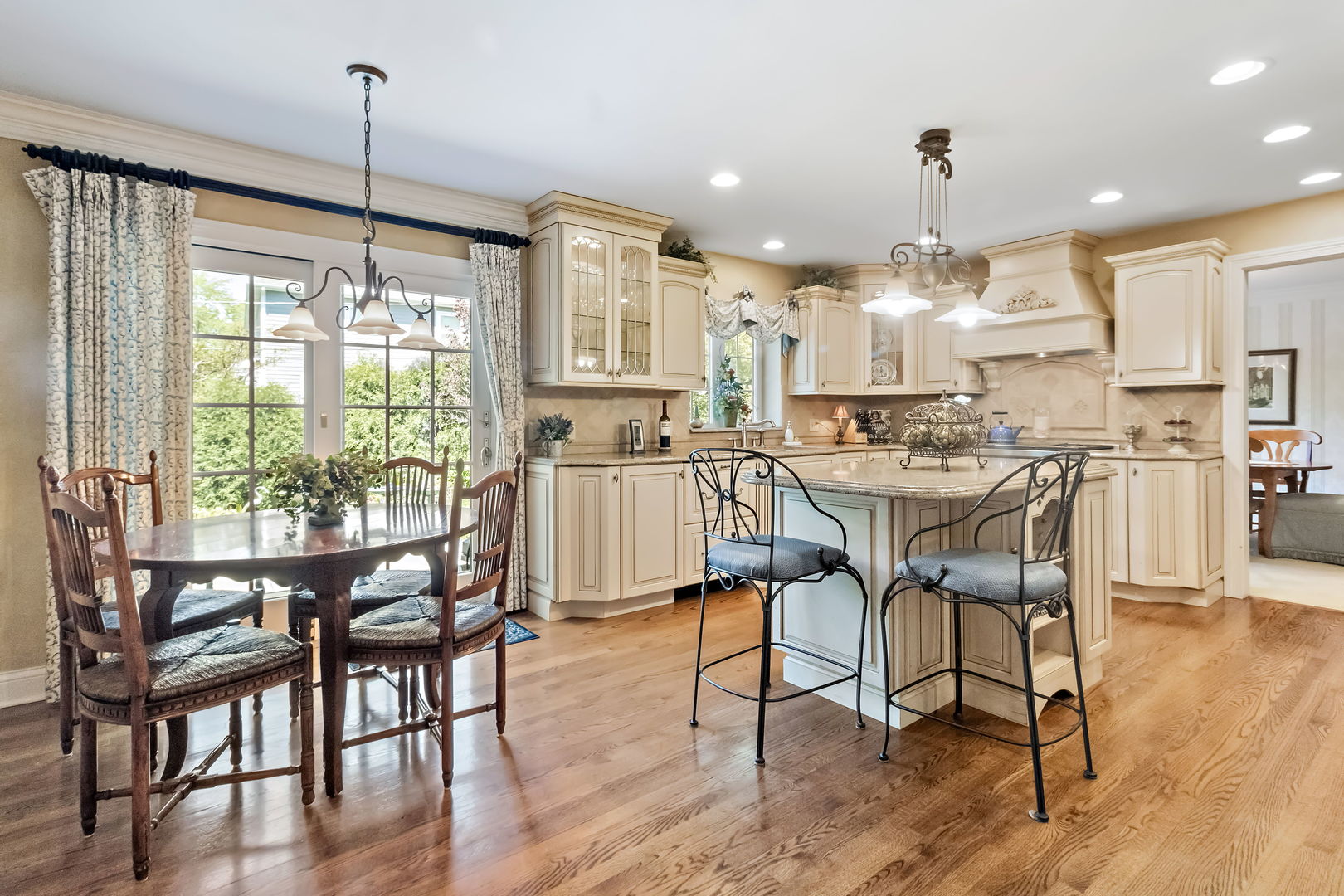 1219 Howard Circle Wheaton, IL 60187 - Photo 8 of 26 a view of a dining room and livingroom with furniture wooden floor a chandelier