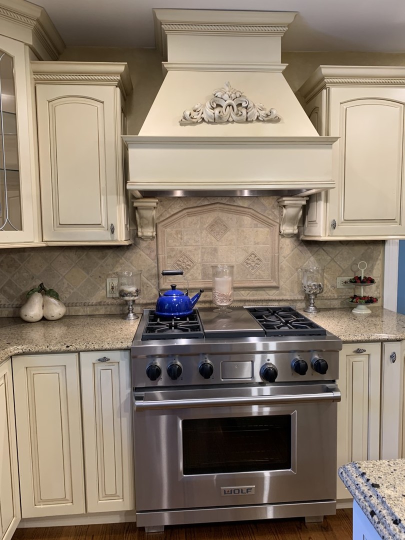 1219 Howard Circle Wheaton, IL 60187 - Photo 10 of 26 a stove top oven sitting inside of a kitchen