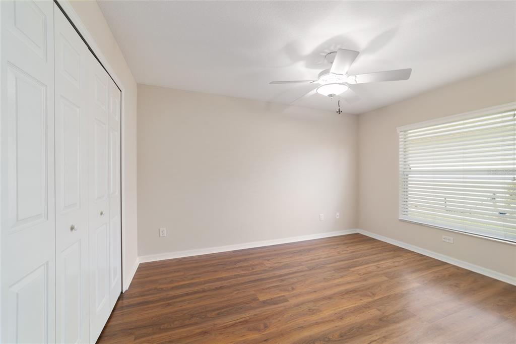 16369 Southwest 14th Avenue Road Ocala, FL 34473 - Photo 37 of 49 a view of an empty room with wooden floor and a window