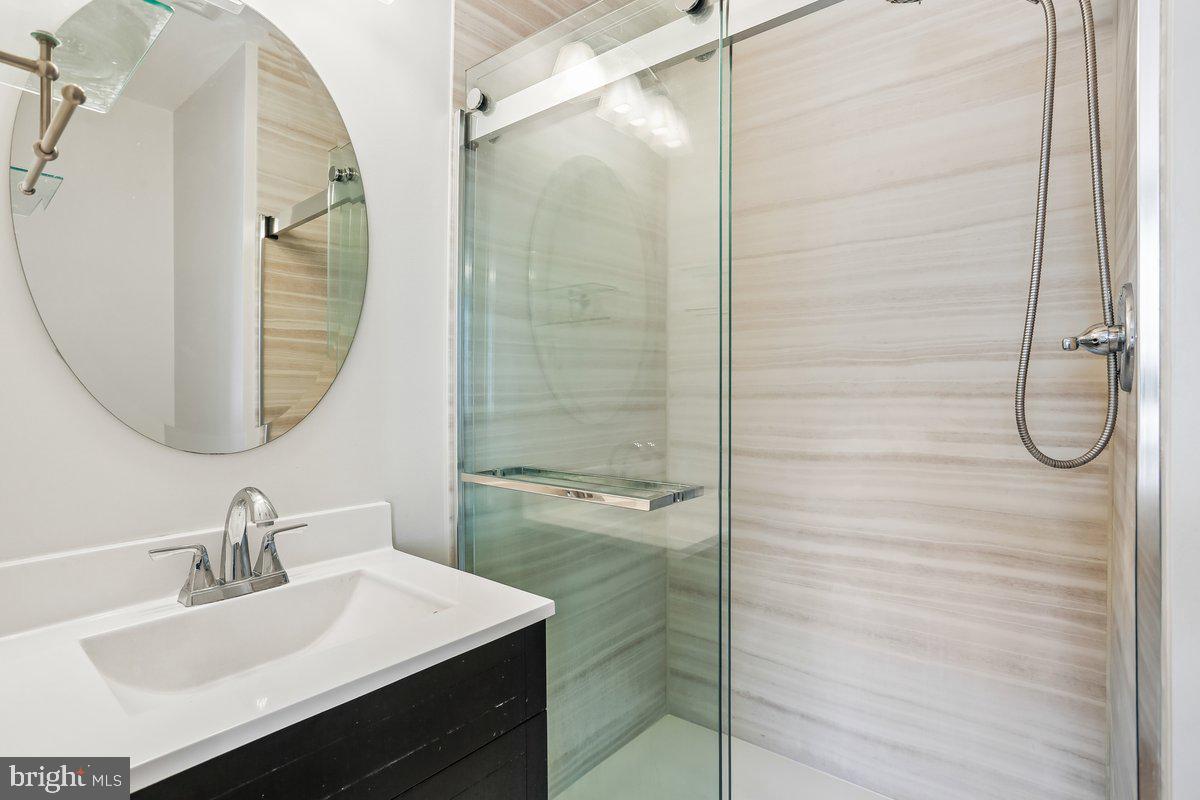 76 Timber Rock Road Gaithersburg, MD 20878 - Photo 25 of 51 a bathroom with a granite countertop sink a mirror and shower