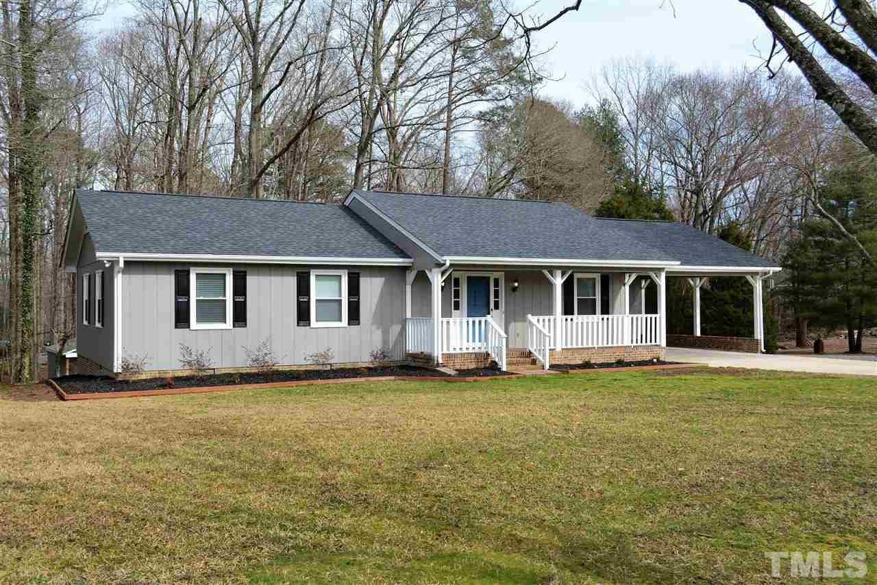 7249 Rock Service Station Road Raleigh, NC 27603 - Photo 2 of 25 All the siding has been sealed and painted*new 30 year Architectual Roof-beautiful*large covered carport*curb appeal with mature Pecan trees and hardwoods*gorgeous lawn & garden areas*extra paved parking*bonus storage building*huge Deck!