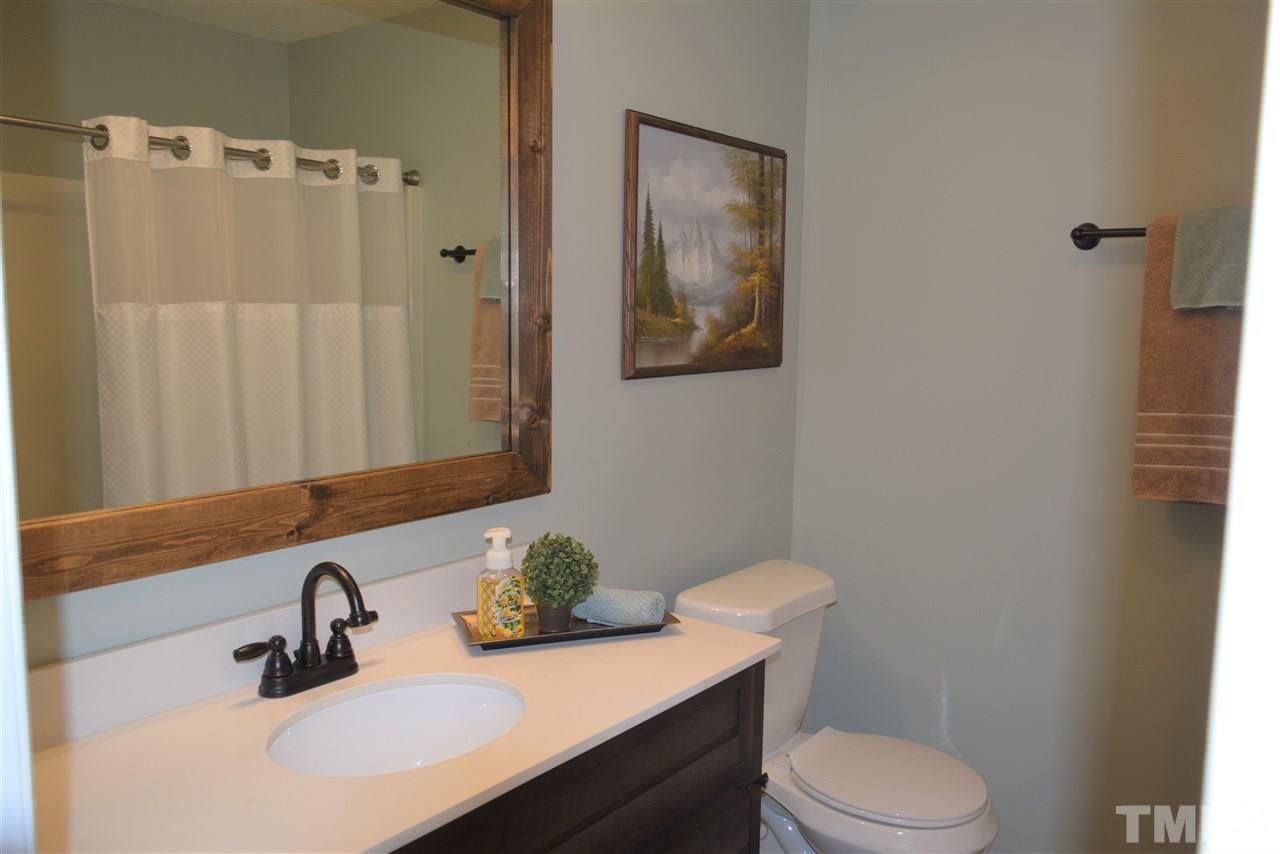 7249 Rock Service Station Road Raleigh, NC 27603 - Photo 17 of 25 Updated new with new vanity, new mirror, new paint and flooring, new toilet