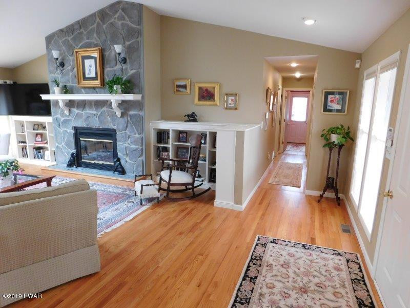 102 Rodeo Lane Hawley, PA 18428 - Photo 7 of 52 a living room with furniture and a fireplace