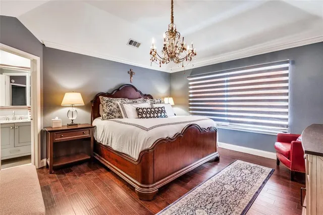 a bedroom with a bed and a chandelier