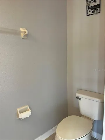 a white toilet sitting next to a shower