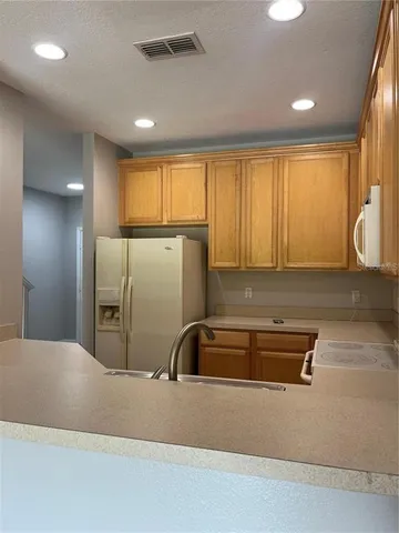 a kitchen with a refrigerator and a sink