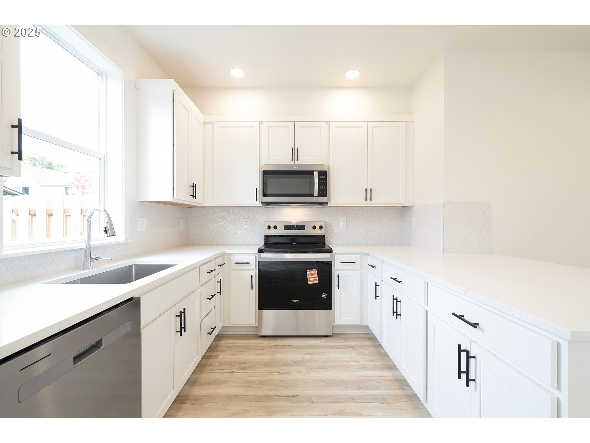 14720 Southeast Powell Boulevard Portland, OR 97236 - Photo 7 of 16 a kitchen with granite countertop a stove top oven sink and cabinets