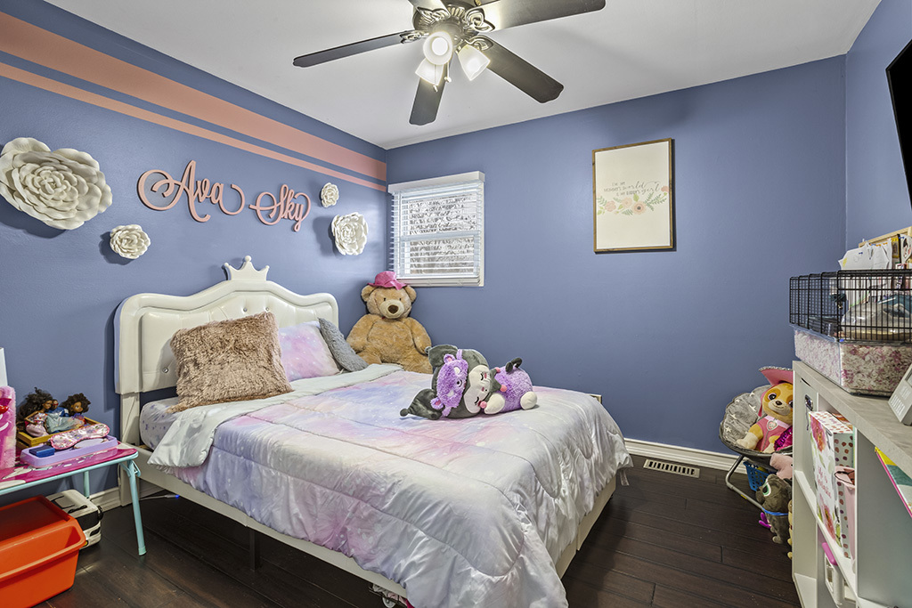 5113 Coulter Road Oak Forest, IL 60452 - Photo 11 of 13 a bedroom with a bed and a chandelier