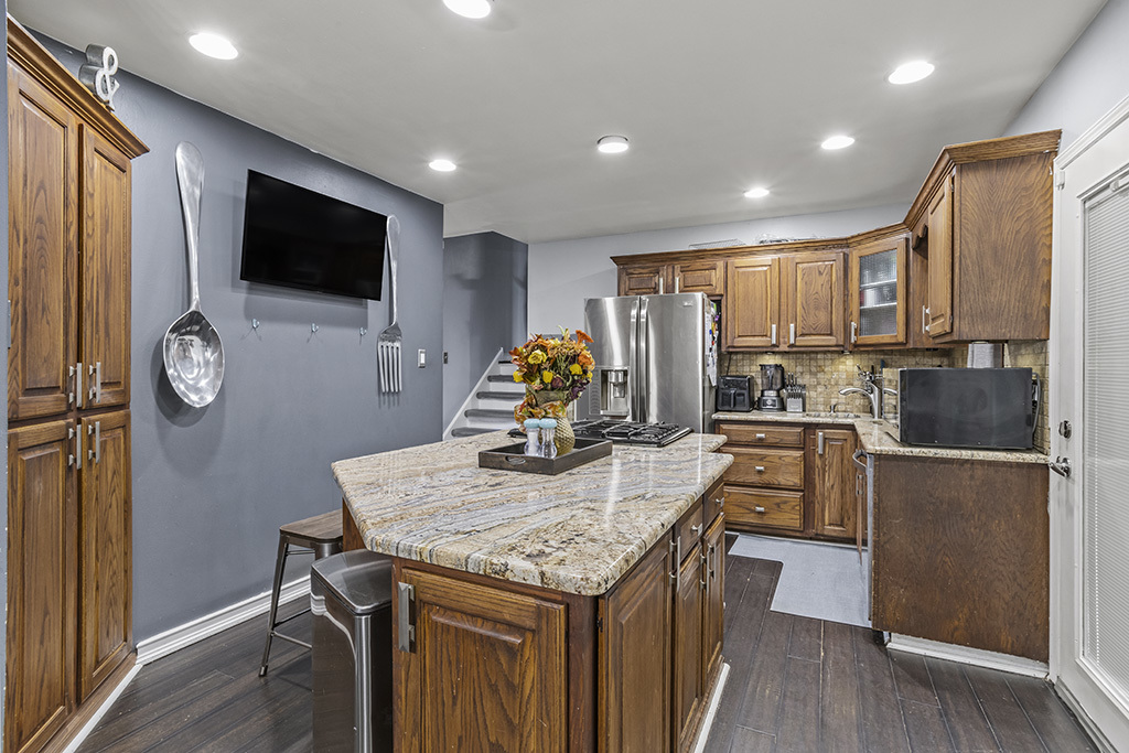 5113 Coulter Road Oak Forest, IL 60452 - Photo 6 of 13 a kitchen with stainless steel appliances microwave stove refrigerator and wooden floor