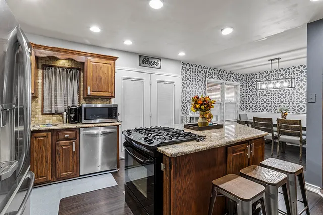 a kitchen that has a table and chairs in it