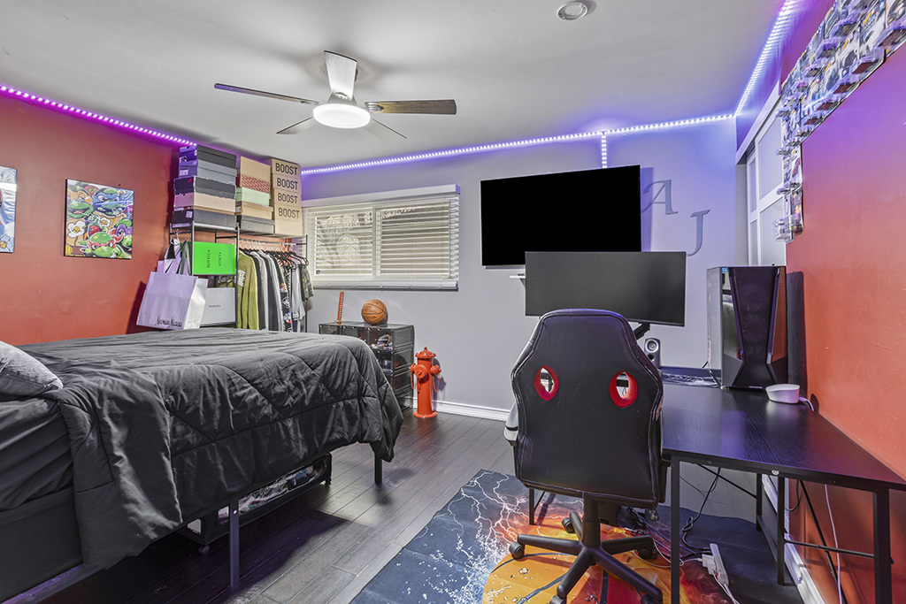 5113 Coulter Road Oak Forest, IL 60452 - Photo 10 of 13 a bedroom with a bed a flat screen tv and a chandelier