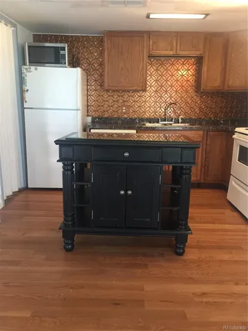 a kitchen with a cabinets and a refrigerator