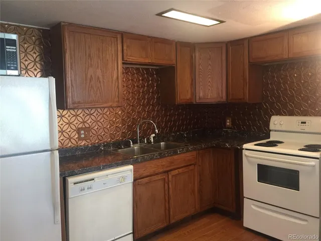 a kitchen with a sink stove and refrigerator