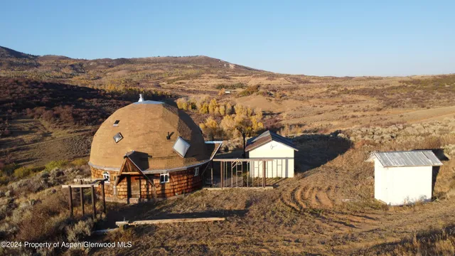an aerial view of a house with a ocean view