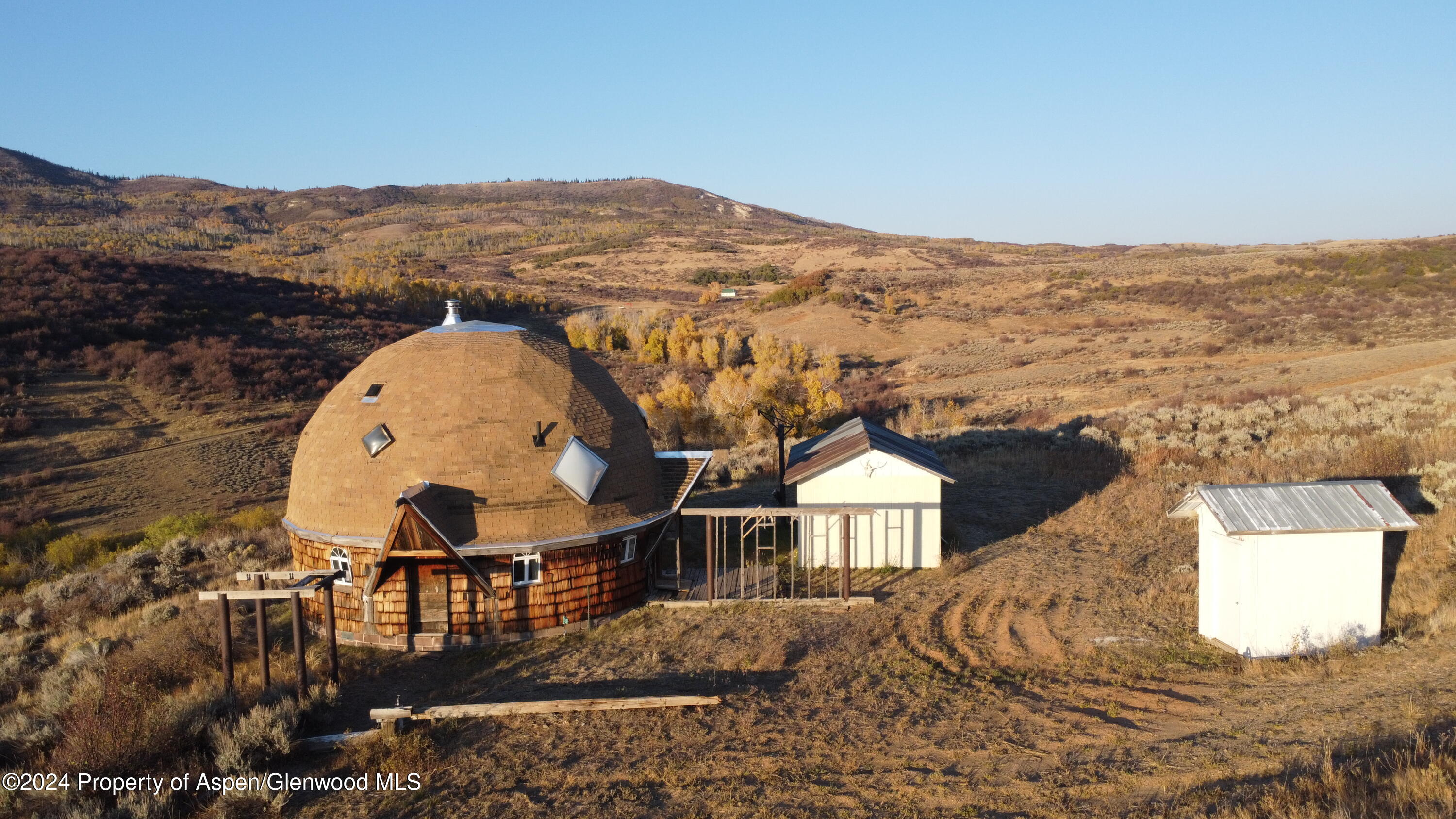 an aerial view of a house with a ocean view