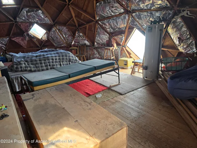 a dining room with furniture and a rug