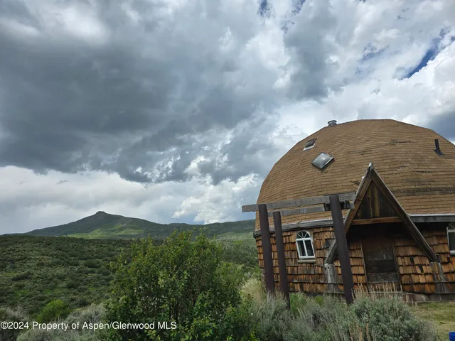 a view of a green field with lots of bushes