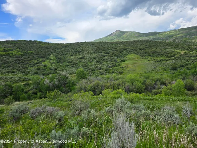 a view of a lake with a house in the background