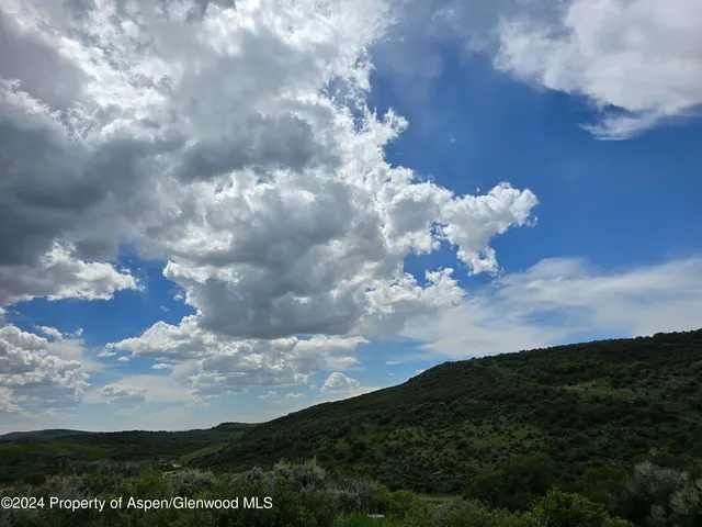 a backyard of a house with lots of green space and fog