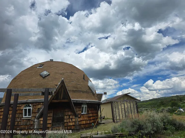 a kitchen with cabinets and chairs
