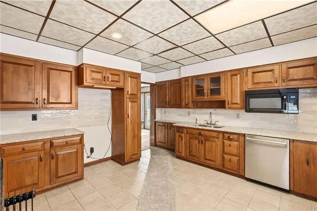 a kitchen with stainless steel appliances granite countertop a sink and cabinets