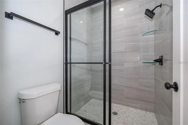 a bathroom with a shower and toilet