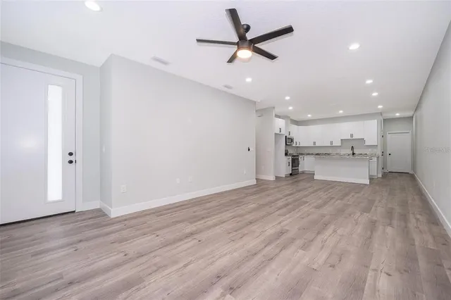 a view of a kitchen with a sink and a refrigerator