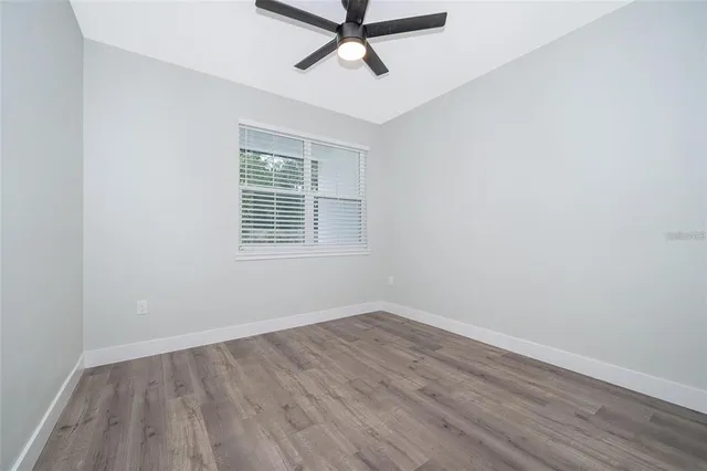 a view of a room with wooden floor and windows