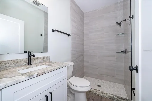 a bathroom with a sink toilet and shower