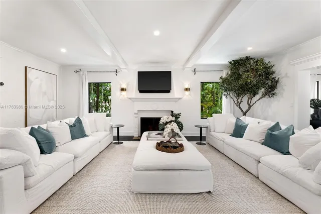 a living room with furniture a fireplace and a flat screen tv