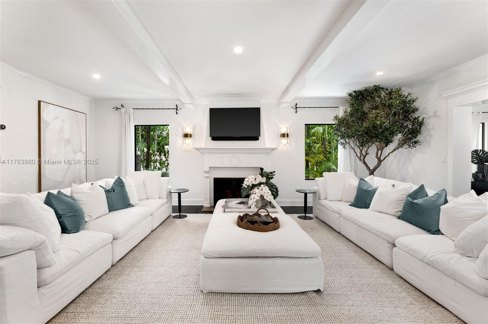 a living room with furniture a fireplace and a flat screen tv
