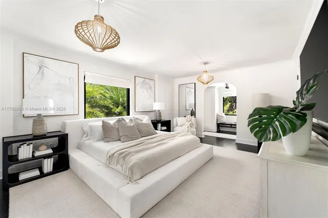 a living room with furniture a chandelier and a large window