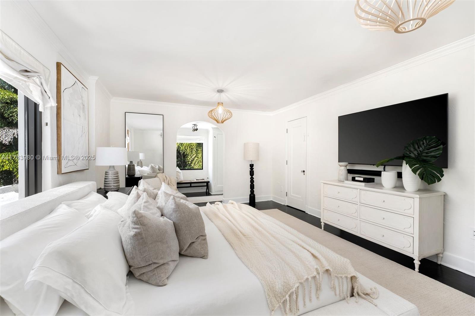4430 Alton Road Miami Beach, FL 33140 - Photo 15 of 47 a bedroom with a bed and a flat screen tv