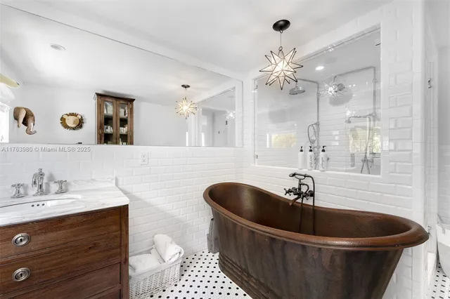a bathroom with a bathtub sink and mirror