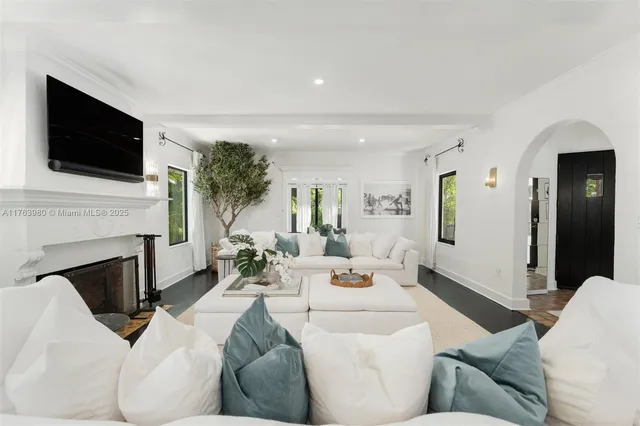 a living room with furniture fireplace and flat screen tv