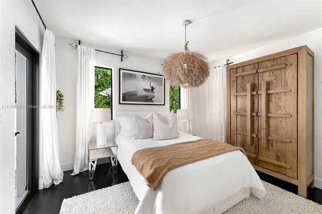 a bedroom with a large bed and a chandelier