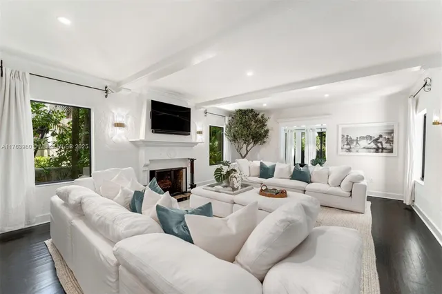 a living room with fireplace furniture and a flat screen tv
