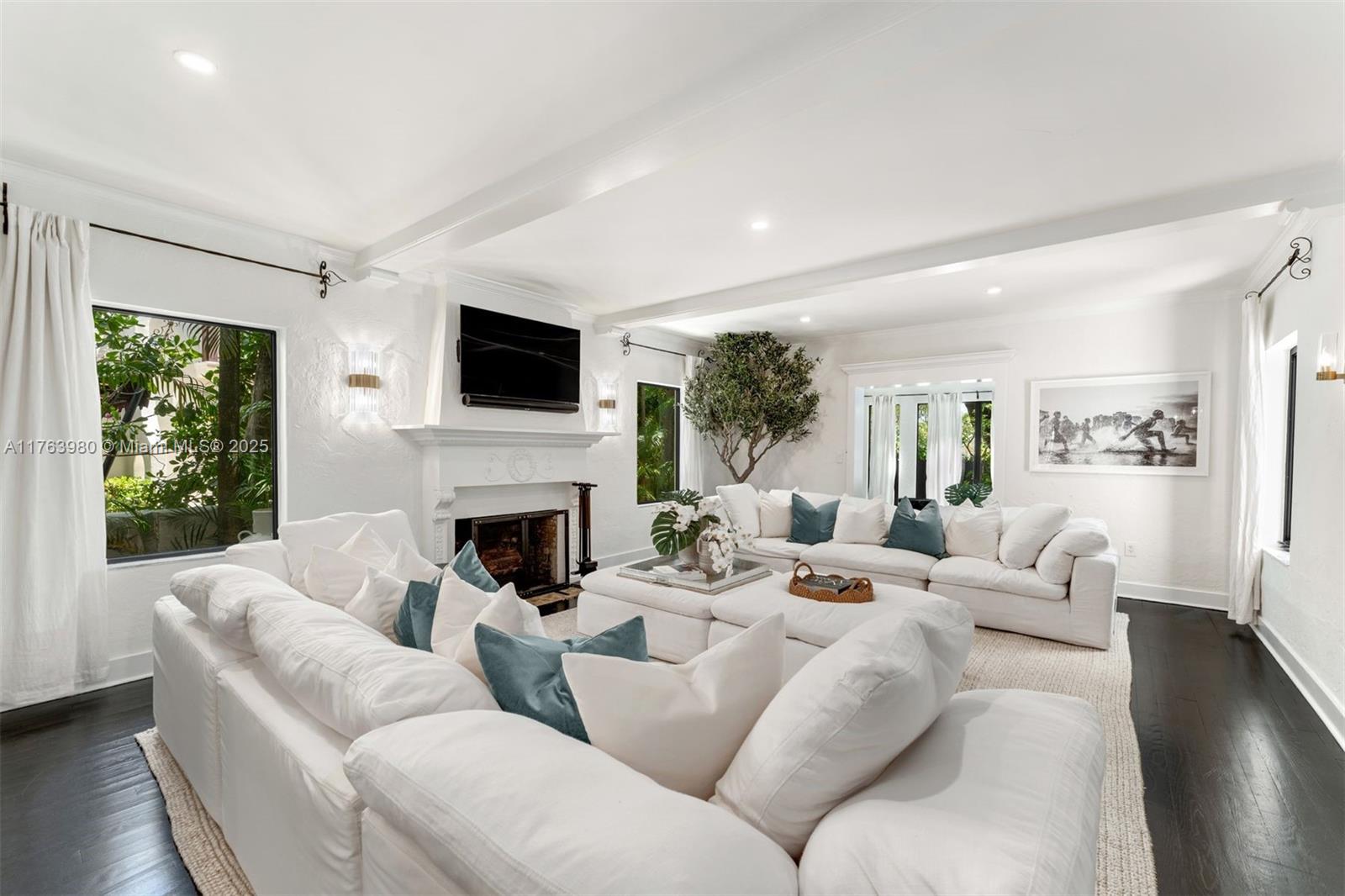 4430 Alton Road Miami Beach, FL 33140 - Photo 3 of 47 a living room with fireplace furniture and a flat screen tv