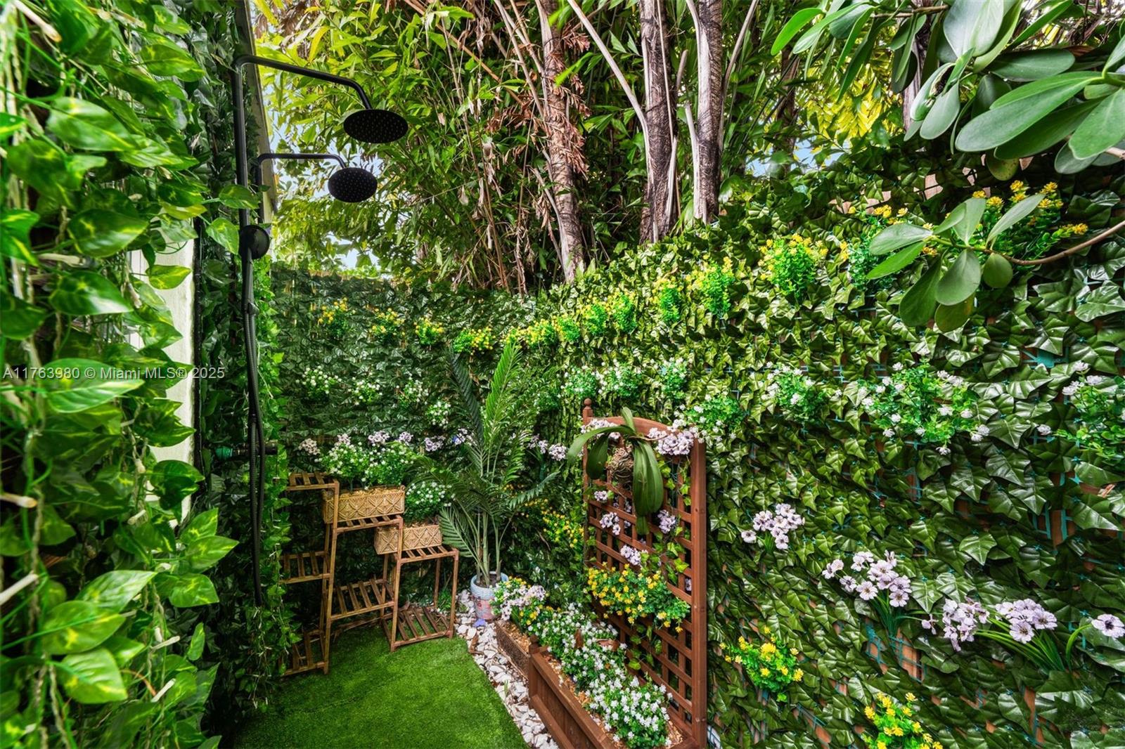 4430 Alton Road Miami Beach, FL 33140 - Photo 36 of 47 a backyard of a house with table and chairs