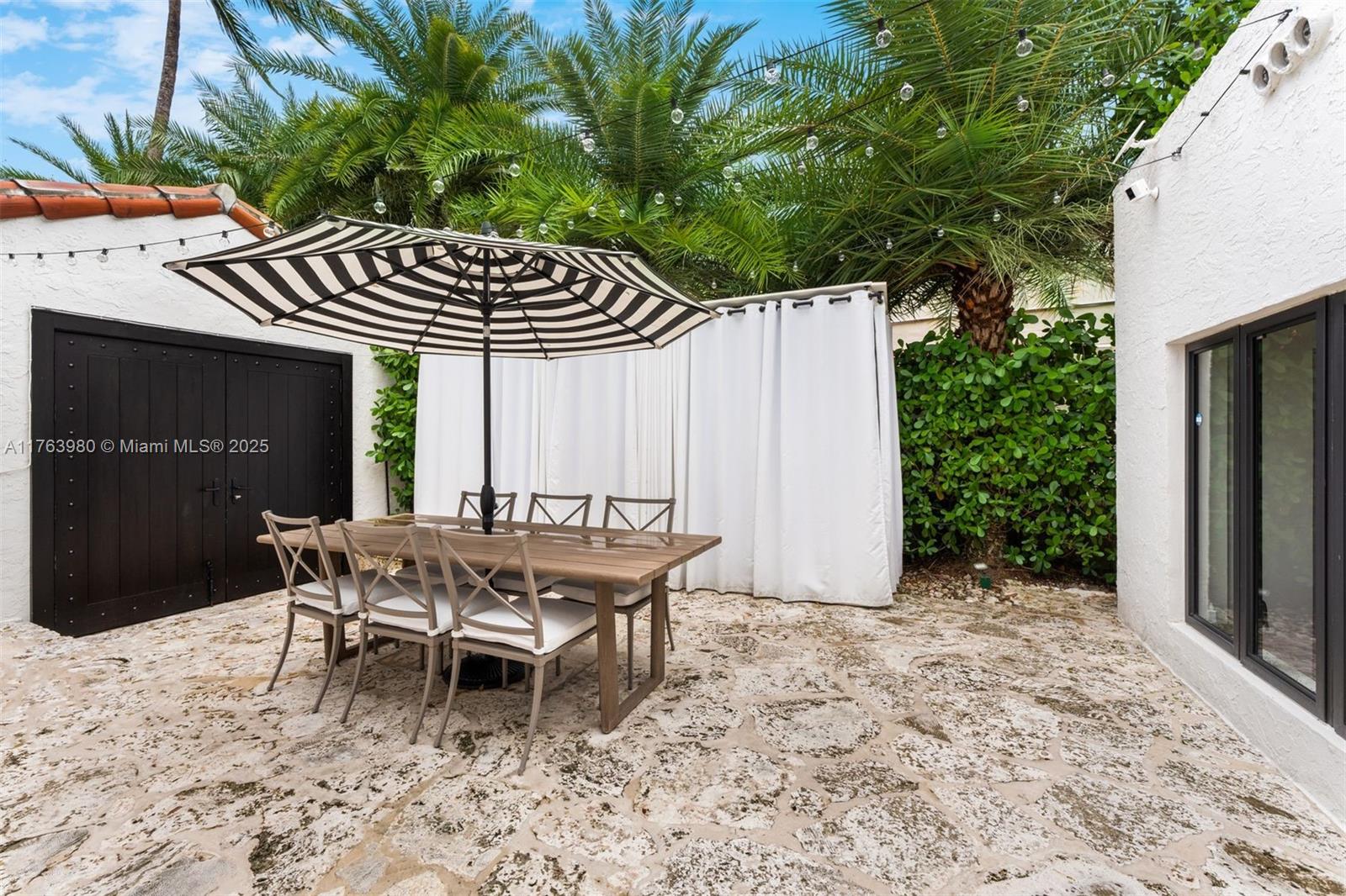 4430 Alton Road Miami Beach, FL 33140 - Photo 37 of 47 a patio with table and chairs